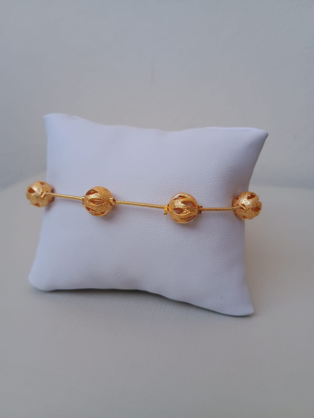 Pulseira dourada com esferas