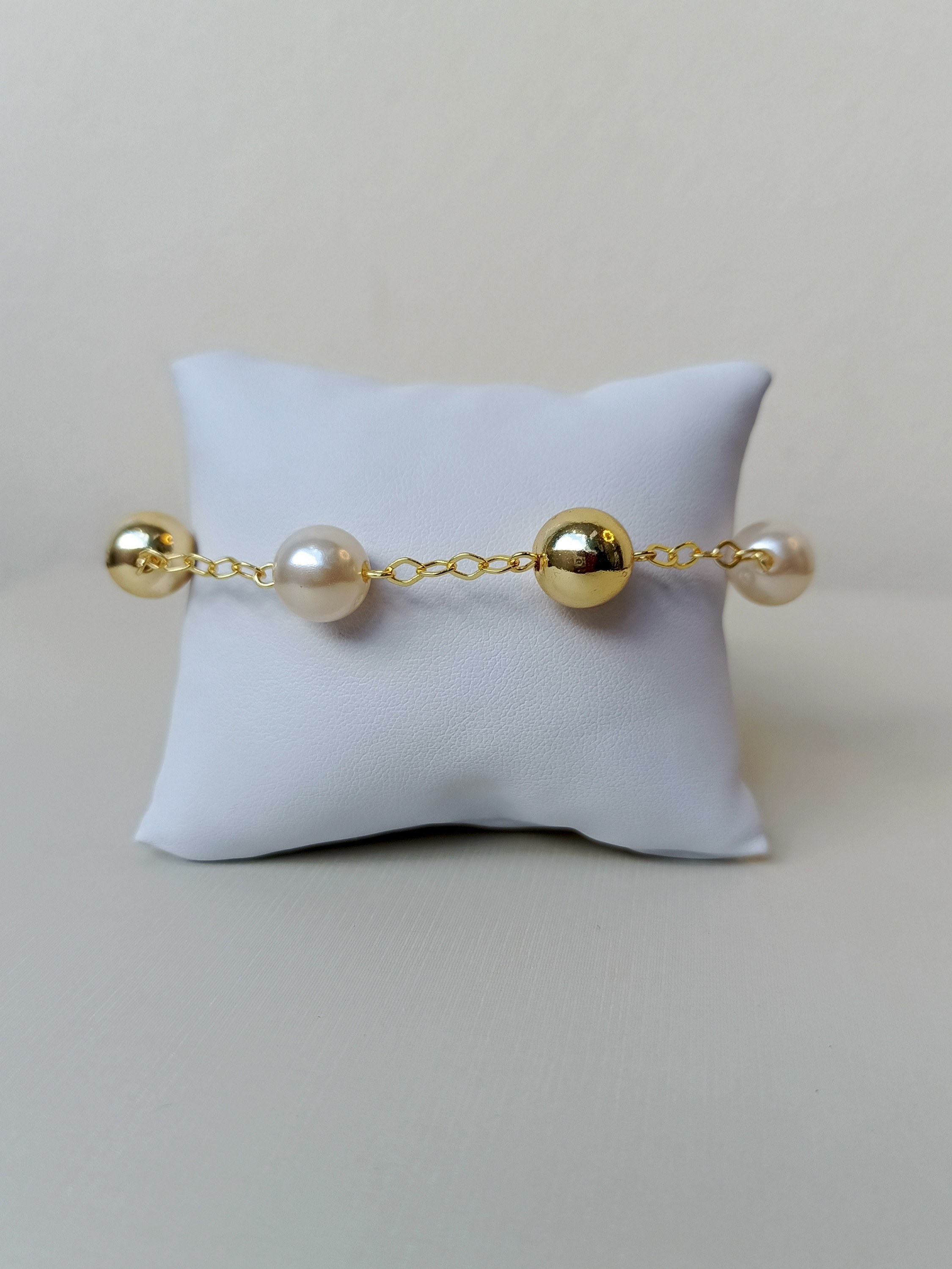 Pulseira com bolinhas douradas e brancas
